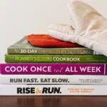 Cookbooks stacked on on a kitchen shelf
