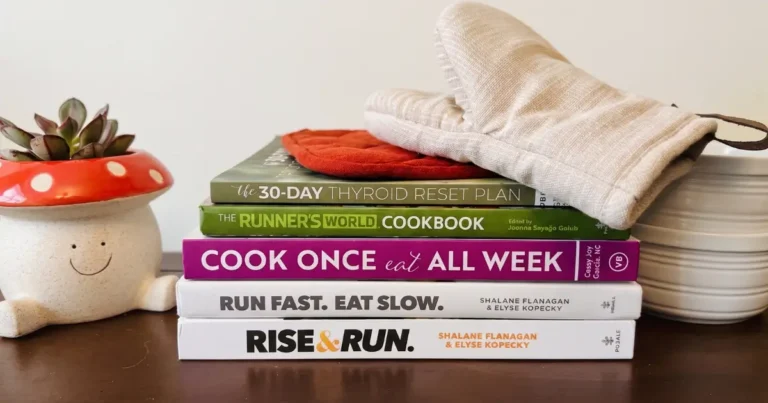 Cookbooks stacked on on a kitchen shelf