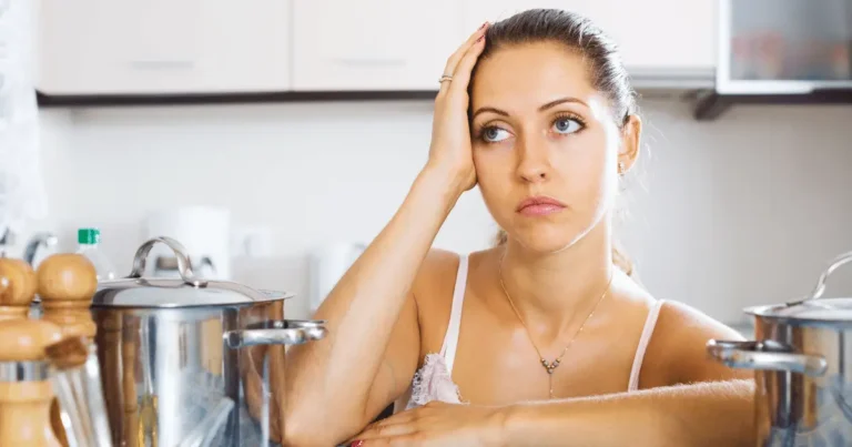 Mom tired in the kitchen with stock pots surrounding her